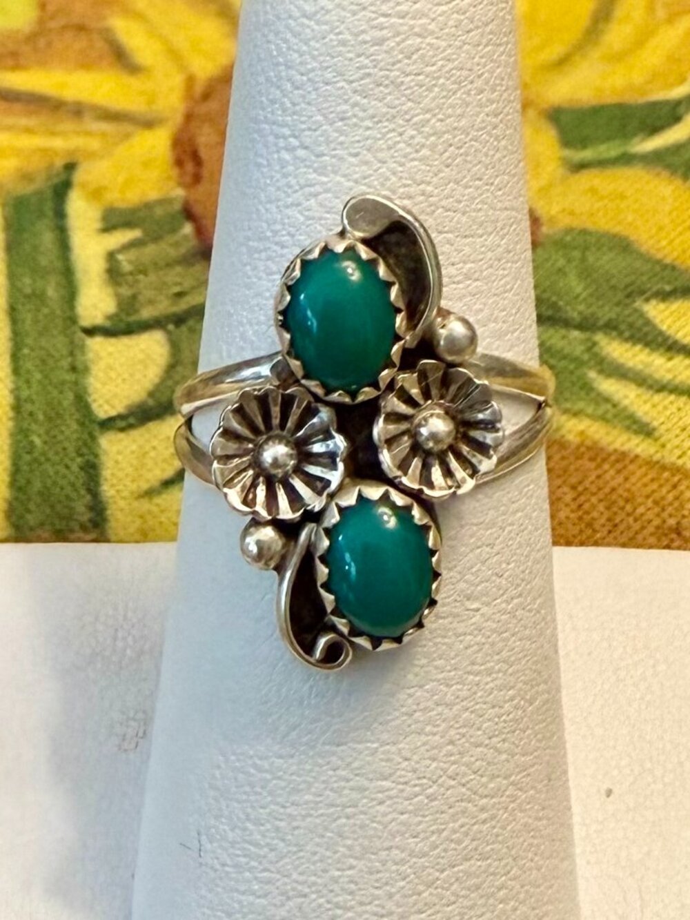 Vintage sterling silver Navajo ring featuring green turquoise stones a